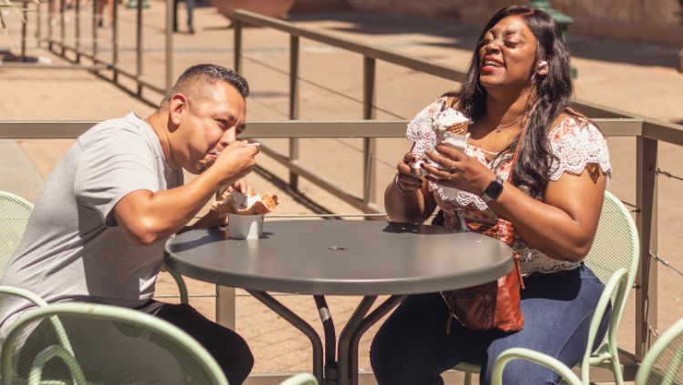 Man and woman enjoying ice cream on a patio