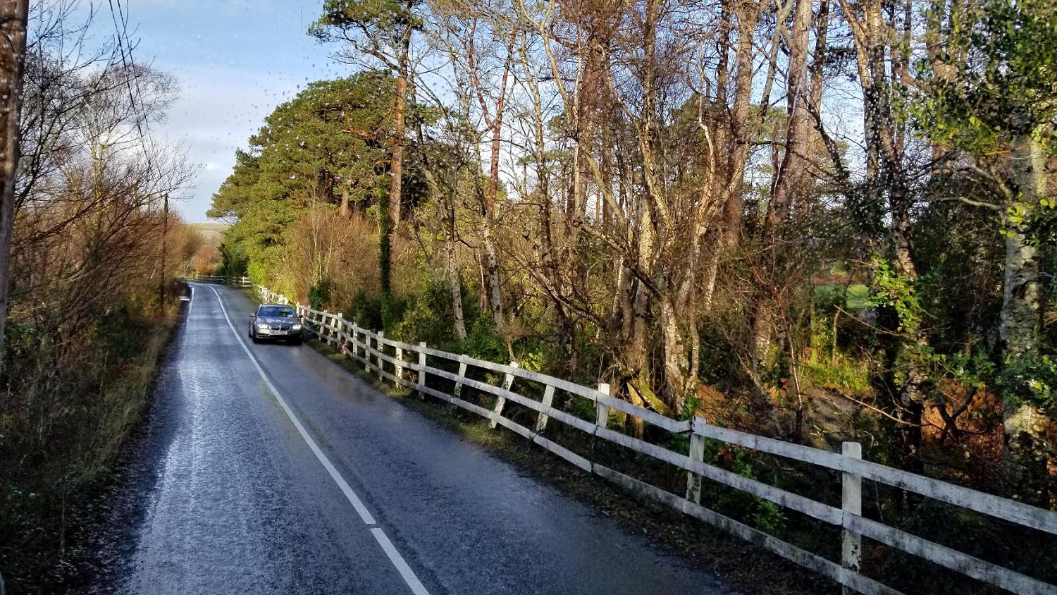 car driving down a country road in Ireland