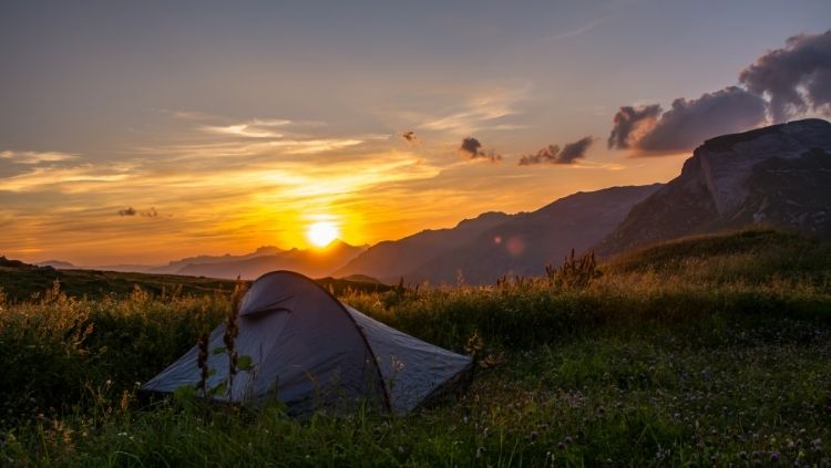 solo camping in a tent, sunrise