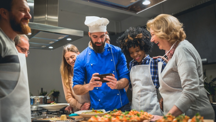 solo traveler over 50 in a cooking class with younger travelers